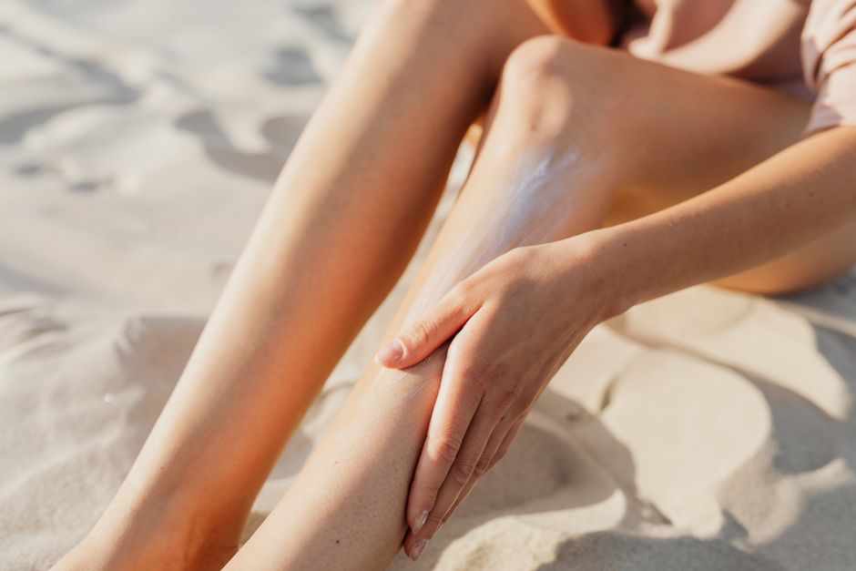 Woman applying sunscreen for UV protection outdoors