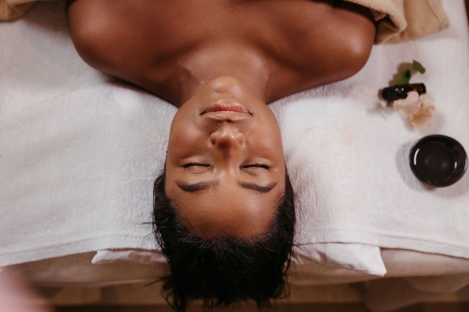 Woman with glowing bronze skin after a custom airbrush spray tan